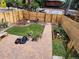 Enclosed backyard with a brick paver patio, lawn, garden beds, and a wood fence for added privacy at 300 S Lincoln St, Denver, CO 80209