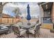 Charming backyard features a brick patio with outdoor dining set, an umbrella, and a cozy seating area at 300 S Lincoln St, Denver, CO 80209