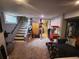 Spacious basement features a large sectional sofa, entertainment area, staircase, and unique cat climbing tree at 300 S Lincoln St, Denver, CO 80209