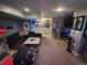 Cozy finished basement features a sectional sofa, modern coffee table, wet bar, and large television at 300 S Lincoln St, Denver, CO 80209