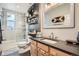 Modern bathroom features glass shower, floating shelves, decorative mirror, and neutral decor at 300 S Lincoln St, Denver, CO 80209