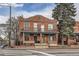 Charming brick two-story home with a balcony and a well-maintained front yard at 300 S Lincoln St, Denver, CO 80209