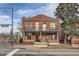 Charming brick two-story home with a balcony and a well-maintained front yard at 300 S Lincoln St, Denver, CO 80209