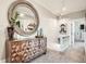 Hallway with textured wooden cabinet, large round mirror, and access to other rooms in the home at 300 S Lincoln St, Denver, CO 80209