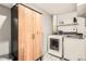 Convenient laundry room with modern washer, dryer, custom storage cabinet, and hanging rack for drying clothes at 300 S Lincoln St, Denver, CO 80209