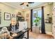 Home office with leafy plants, large window, and modern desk setup at 300 S Lincoln St, Denver, CO 80209