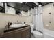 Bathroom featuring a vanity, toilet, and shower/tub with a decorative shower curtain at 1390 N Emerson St # 101, Denver, CO 80218