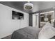Bedroom featuring mounted TV, soft bedding, mirrored closet, and modern fan fixture at 1390 N Emerson St # 101, Denver, CO 80218
