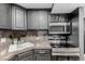 Efficient kitchen featuring stainless steel appliances, sleek counters, and dark cabinets at 1390 N Emerson St # 101, Denver, CO 80218