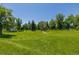 Lush green park with walking paths surrounded by mature trees at 1390 N Emerson St # 101, Denver, CO 80218