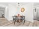 Bright dining area showcasing modern lighting, a round table with stylish chairs, and an open layout at 3313 Jasmine St, Denver, CO 80207