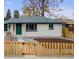 Charming home boasts a green door, fresh landscaping, and a new fence at 3313 Jasmine St, Denver, CO 80207