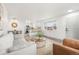 Cozy living space with a comfortable sofa, stylish accents, and open layout leading to dining and kitchen areas at 3313 Jasmine St, Denver, CO 80207