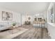 Open-concept living space showcasing stylish decor with a sofa, dining area, bar seating, and modern kitchen at 3313 Jasmine St, Denver, CO 80207