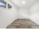 Bright, neutral room featuring wood-look flooring and a window at 3313 Jasmine St, Denver, CO 80207
