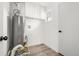 Utility room featuring wood-look flooring and a water heater at 3313 Jasmine St, Denver, CO 80207