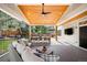 Beautiful covered back deck featuring a large outdoor dining table and comfortable cushioned sofa at 16658 Black Oak Ct, Parker, CO 80134