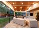 Wonderful covered back deck boasting a ceiling fan, outdoor dining table, and comfortable seating at 16658 Black Oak Ct, Parker, CO 80134