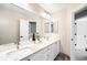 Well-lit bathroom features double sink vanity with granite countertops and oversized mirror at 16658 Black Oak Ct, Parker, CO 80134