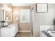 Well-lit bathroom featuring double sink vanity, granite counters, and a glass enclosed shower at 16658 Black Oak Ct, Parker, CO 80134
