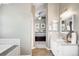 Hallway with bedroom view leads to a bathroom with double vanity and bright lighting fixtures at 16658 Black Oak Ct, Parker, CO 80134