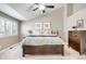 Spacious bedroom with vaulted ceilings, bright windows, a ceiling fan, and a rustic wood dresser at 16658 Black Oak Ct, Parker, CO 80134