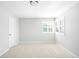 Neutral-toned bedroom features light carpeting, and large window with plantation shutters at 16658 Black Oak Ct, Parker, CO 80134