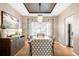Dining room featuring modern decor, a large table, a decorative chandelier, and window shutters at 16658 Black Oak Ct, Parker, CO 80134