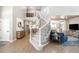 Elegant foyer with a curved staircase, hardwood floors, and views into the living room and kitchen at 16658 Black Oak Ct, Parker, CO 80134
