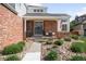 Inviting front porch with brick facade, flower boxes, a seating area, and a stone walkway at 16658 Black Oak Ct, Parker, CO 80134