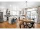 Bright kitchen features stainless steel appliances, quartz countertops, island with seating, and a hardwood floor at 16658 Black Oak Ct, Parker, CO 80134