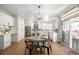 Bright kitchen with white cabinets, stainless steel appliances, a dining area, and a sliding door to the outdoors at 16658 Black Oak Ct, Parker, CO 80134