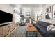 Spacious living room with a fireplace, comfortable seating, a large TV, and stylish decor at 16658 Black Oak Ct, Parker, CO 80134