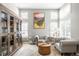Cozy living room with plush seating, a wooden bookcase, and ample natural light from multiple windows at 16658 Black Oak Ct, Parker, CO 80134