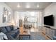Open-concept living room with hardwood floors, access to the kitchen, and stylish furniture at 16658 Black Oak Ct, Parker, CO 80134