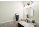 Stylish half bathroom featuring decorative tile backsplash, a modern mirror, and updated fixtures at 16658 Black Oak Ct, Parker, CO 80134
