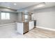 Basement bar featuring modern appliances, white cabinets, hardwood-style flooring, and neutral gray walls at 578 Sage Grouse Cir, Castle Rock, CO 80109