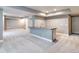 Spacious unfinished basement with gray walls, carpeted floors, and a large center island with sink at 578 Sage Grouse Cir, Castle Rock, CO 80109