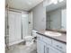 Bathroom with tiled floors, walk-in shower, and a white vanity with a countertop sink at 578 Sage Grouse Cir, Castle Rock, CO 80109
