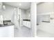 Bright bathroom with double vanity, sleek cabinets, gray flooring, and a walk-in shower with bench seating at 578 Sage Grouse Cir, Castle Rock, CO 80109