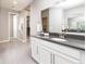 A sleek bathroom features a white vanity with a dark countertop and a large mirror reflecting the open space at 578 Sage Grouse Cir, Castle Rock, CO 80109