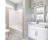 Bright bathroom with a white vanity, bathtub, and shower combination with tile surround at 578 Sage Grouse Cir, Castle Rock, CO 80109