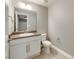 Half bathroom featuring tile flooring, a white vanity with countertop sink, and a neutral gray wall color at 578 Sage Grouse Cir, Castle Rock, CO 80109