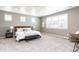 Large bedroom with ample natural light, neutral carpet, and space for a sitting area at 578 Sage Grouse Cir, Castle Rock, CO 80109