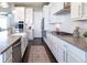 Contemporary kitchen with stainless steel appliances, white subway tile, and a stylish area rug at 578 Sage Grouse Cir, Castle Rock, CO 80109