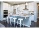 Bright kitchen boasts white cabinets, stainless steel appliances, and an island with bar stool seating at 578 Sage Grouse Cir, Castle Rock, CO 80109
