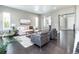 Spacious living room with stone fireplace, comfortable seating, dark floors, and open floor plan at 578 Sage Grouse Cir, Castle Rock, CO 80109