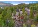 Stunning aerial view of a home nestled among lush greenery and mature trees at 30082 Troutdale Ridge Rd, Evergreen, CO 80439