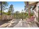 Relaxing back deck offers wooded views, outdoor seating, and peaceful ambiance at 30082 Troutdale Ridge Rd, Evergreen, CO 80439