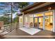 Spacious back deck with serene views, outdoor seating, and access to the interior at 30082 Troutdale Ridge Rd, Evergreen, CO 80439